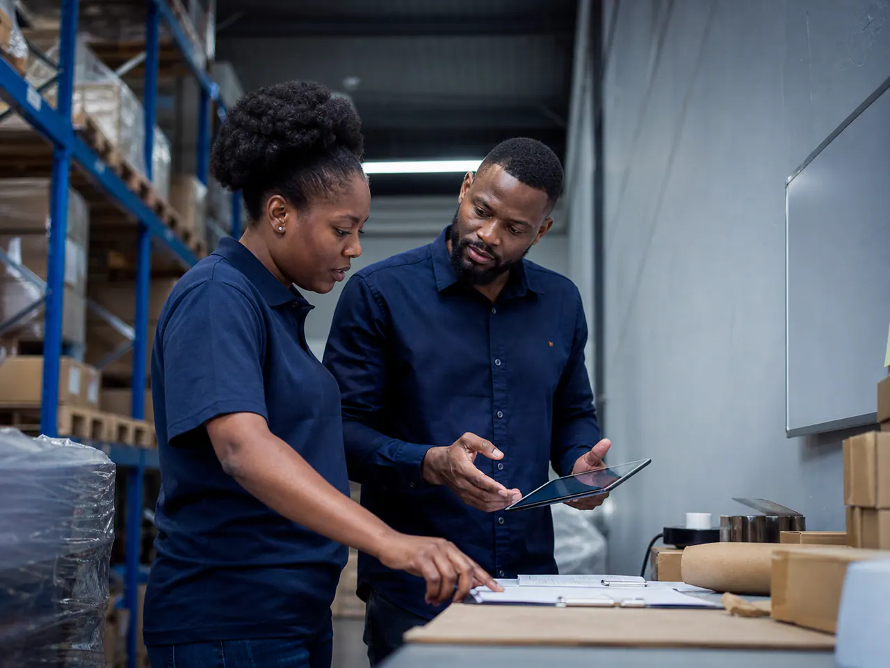 African contractor operations leaders reviewing project activity in a warehouse